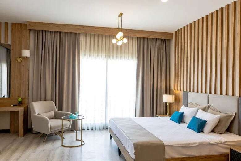 Paradisos Hotel Nicosia — bright guest room with wooden detailing